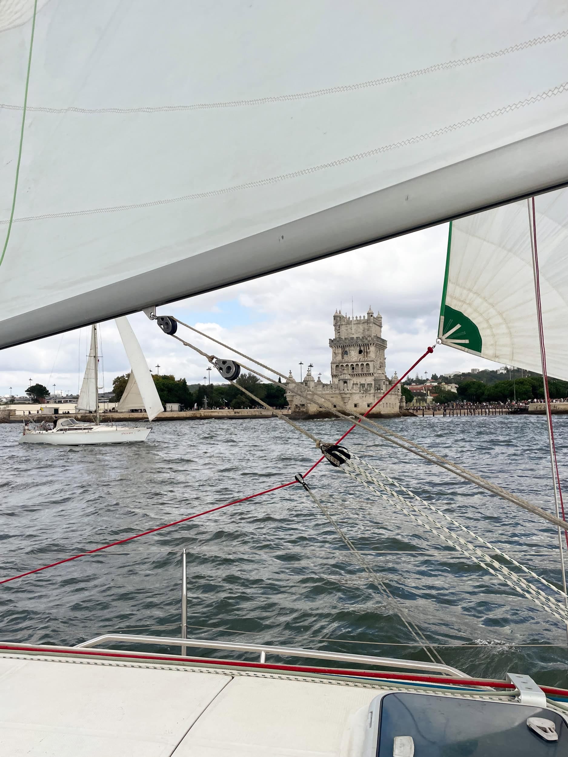 A crew member hoisting a sail aboard a yacht